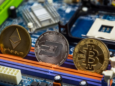 A computer's motherboard holding various forms of cryptocurrency.