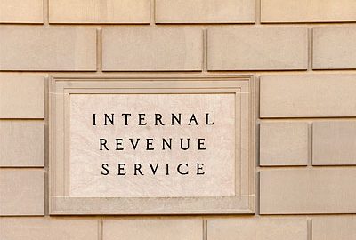 A white stone wall with an "Internal Revenue Service" plaque.