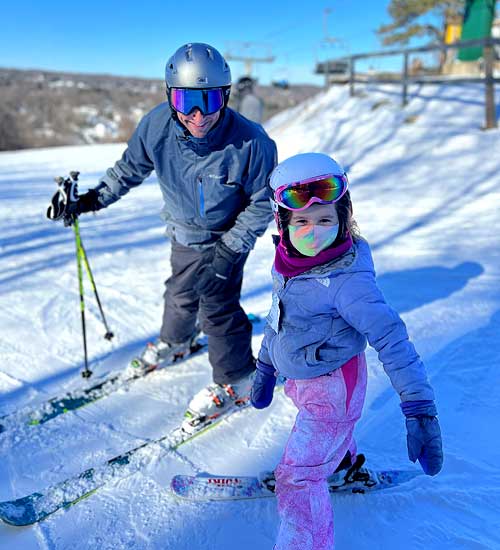 Eric Gashin skiing with his daughter