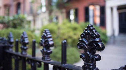 Iron rod fence in front of affluent home